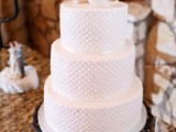 a white polka dot wedding cake with love birds topping it is a cool and stylish idea for any wedding, such toppers aren’t seen every time