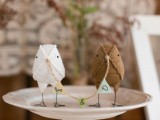a fun DIY cake topper of two fabric birds holding a banner is a cool and lovely idea for a rustic wedding