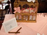 a cage with little love birds that are used for leaving wishes for the couple are a lovely and cute idea for any wedding