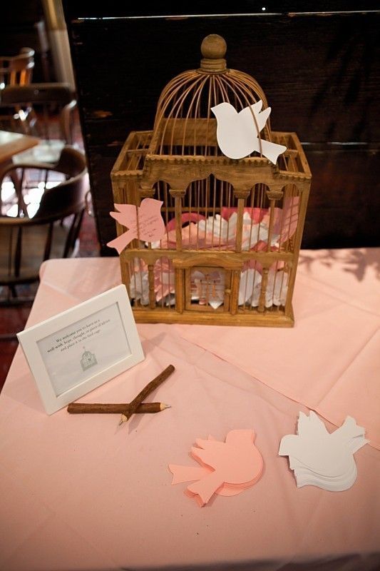 A cage with little love birds that are used for leaving wishes for the couple are a lovely and cute idea for any wedding