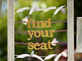 an ornated frame with feathers as a sign to find a seat is a cool and cute idea for a rustic wedding, make one yourself