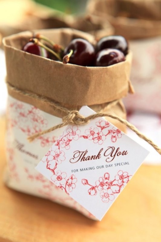 paper bags with personalized tags and fresh cherries are great favors for summer rehearsal dinners or late summer ones