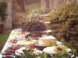 a fantastic cheese and grapes food bar decorated with greenery is a cool food station idea for a Tuscany wedding
