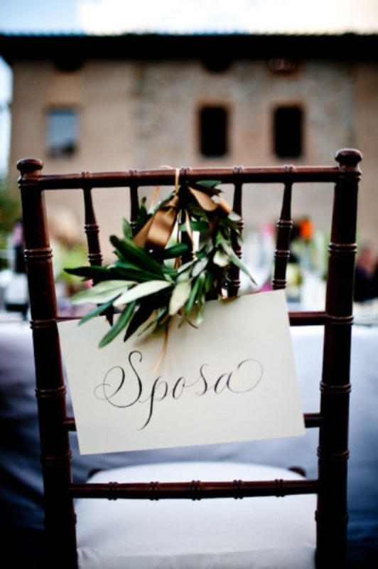Decorate your wedding chairs with signs in Italian and olive wreaths for embracing the location