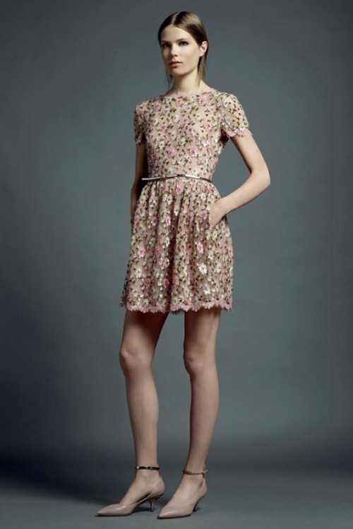 an eye-catchy floral A-line mini wedding guest dress with a high neckline and short sleeves, a metallic belt and nude heels for a spring or summer wedding