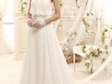 a vintage-inspired a-line halter neckline wedding dress with a draped bodice, an embellished sash and gloves