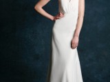 a plain sheath wedding dress with a halter neckline and a feather clip to make it stand out