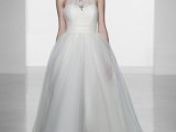 a princess-style wedding dress with an embellished halter neckline, a full skirt and a birdcage veil