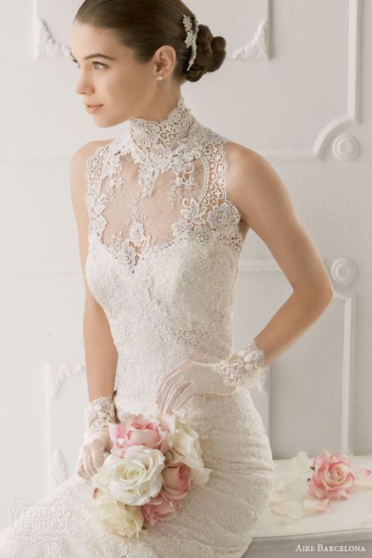 a romantic lace sheath halter neckline wedding dress and matching lace gloves for a glam look