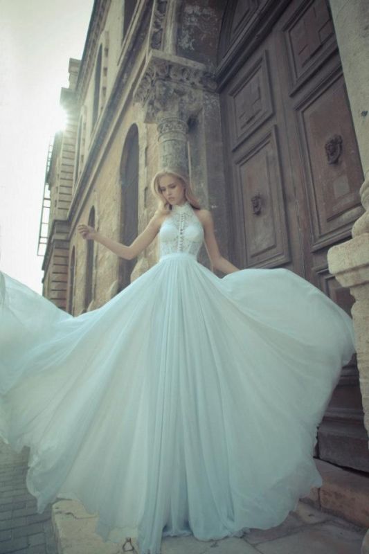 A vintage inspired A line halter neckline lace wedding dress with a button up bodice