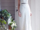a lace sheath halter neckline wedding dress accented with a grey belt is a creative combo