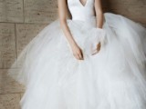a halter neckline princess style wedding dress with a plain bodice and a full skirt of layers is a unique combo