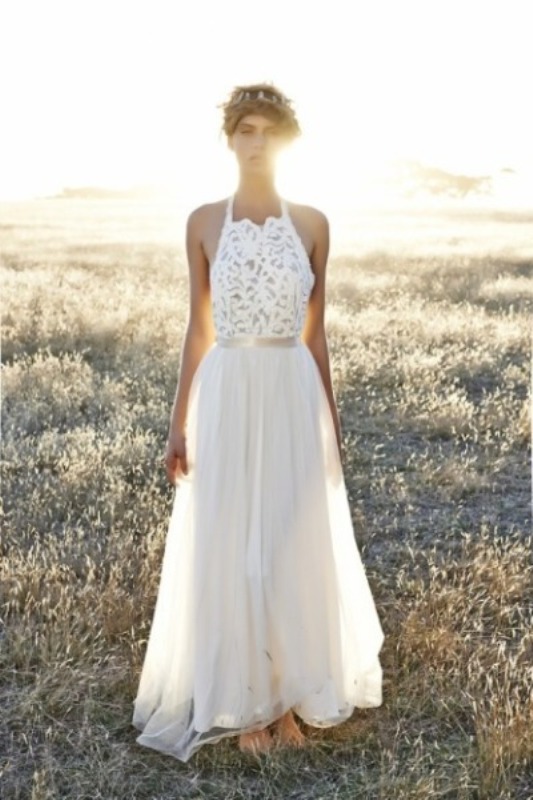 An A line boho wedding dress with a lace halter neckline bodice and a plain skirt
