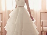 a sleeveless A-line wedding dress with a layered skirt, a lace bodice and a silver belt