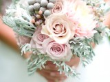 a pastel wedding bouquet with pale millet, pink roses and some berries for a spring or summer bride