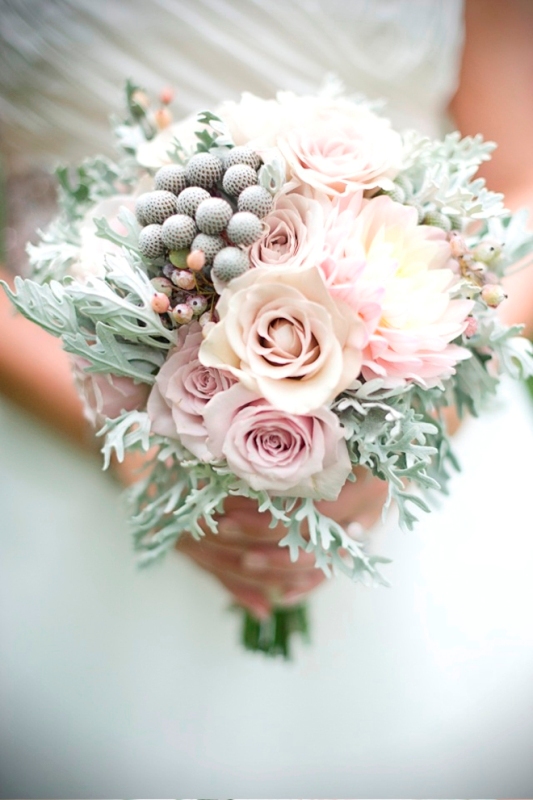 A pastel wedding bouquet with pale millet, pink roses and some berries for a spring or summer bride