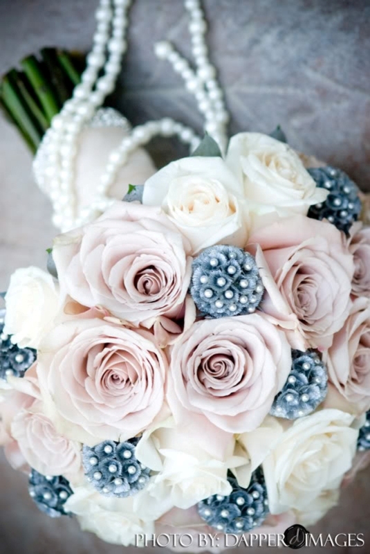 A dusty pink and white rose wedding bouquet accented with pearls is a cool and fresh idea