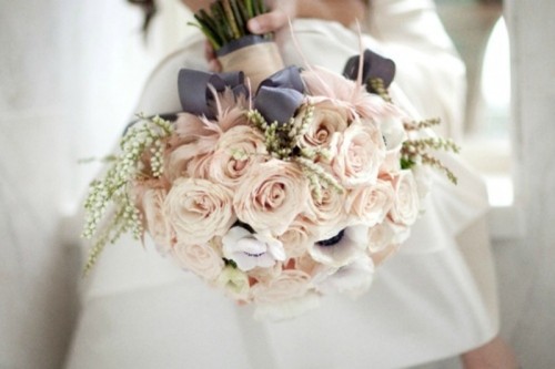 a romantic blush rose wedding bouquet with some berries and dark ribbons for a chic look