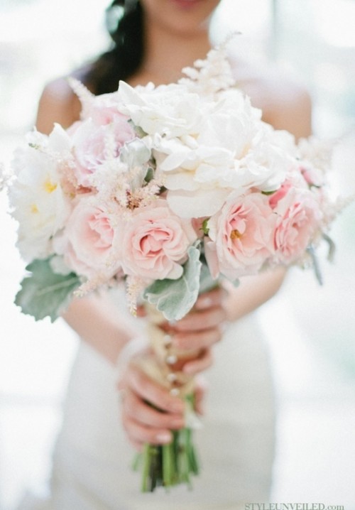 a chic wedding bouquet of white and blush blooms and some pale greenery plus plenty of texture
