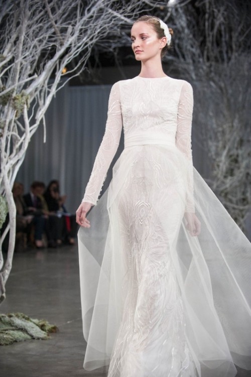 a fitting lace wedding dress with a high neckline and long sleeves, with a sheer overskirt is a great idea for a refined wedding with a church ceremony