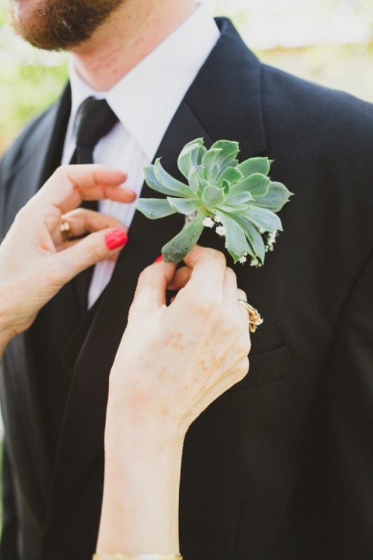 an oversized succulent plus baby's breath is a lovely boutonniere for a modern groom's look