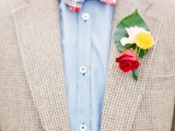 a bold floral boutonniere of white, yellow and red blooms and a single grene leaf is always a cool and fun idea to rock