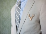 a gilded deer head with antlers is a cool and glam accessory for a modern woodland groom’s look