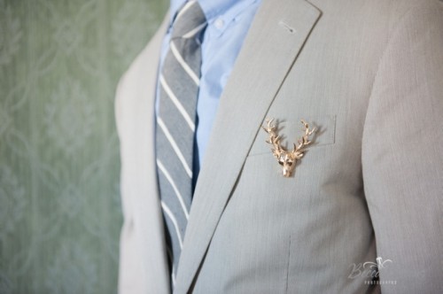 a gilded deer head with antlers is a cool and glam accessory for a modern woodland groom's look
