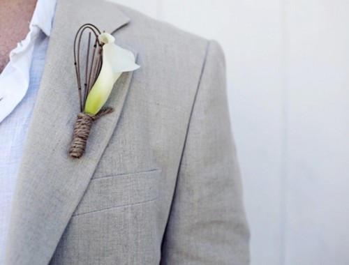 a modern boutonniere of a single white calla bloom with twigs is a cool idea for a modern tropical groom's look