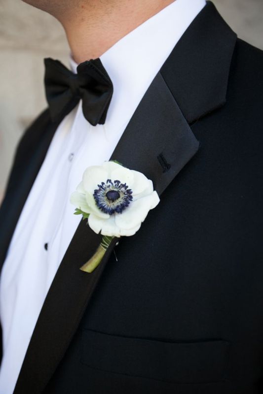 a white anemone wedding boutonniere is a chic and catchy idea for a modern and refined groom's look