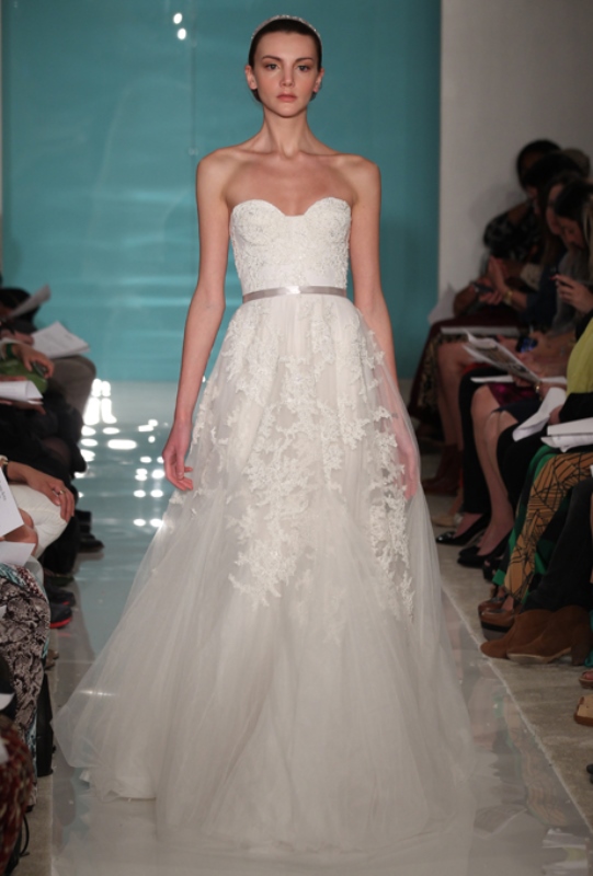 A strapless A line wedding dress with lace appliques and a tulle skirt plus a metallic belt is adorable