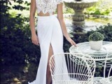 an ultra-modern two piece wedding dress with a lace crop top and a wrap maxi skirt with a train is chic and sexy