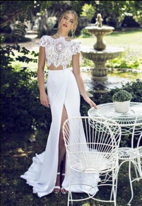 an ultra-modern two piece wedding dress with a lace crop top and a wrap maxi skirt with a train is chic and sexy