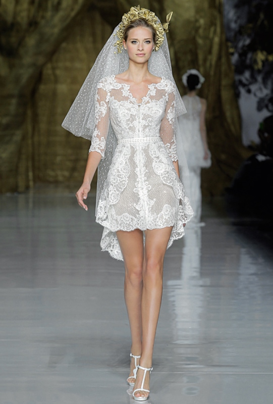 A short lace A line wedding dress with short sleeves and a V neckline plus a matching veil for a modern glam bride