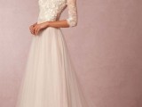 an a-line wedding dress with a lace bodice with a bateau neckline and short sleeves plus a pleated skirt with a train