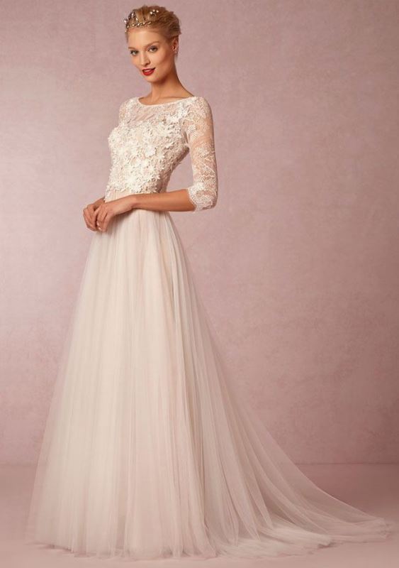An a line wedding dress with a lace bodice with a bateau neckline and short sleeves plus a pleated skirt with a train
