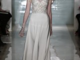 a modern wedding dress with a lace bodice and a plain pleated skirt with a train for a contrasting and chic look