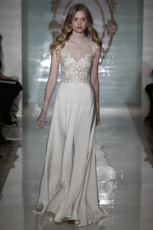 a modern wedding dress with a lace bodice and a plain pleated skirt with a train for a contrasting and chic look