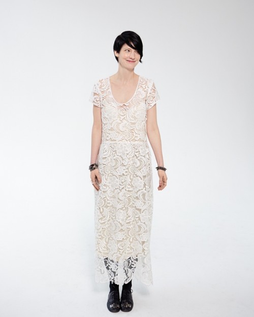 a relaxed boho lace wedding dress with short sleeves and a deep neckline plus black embellished shoes and black accessories