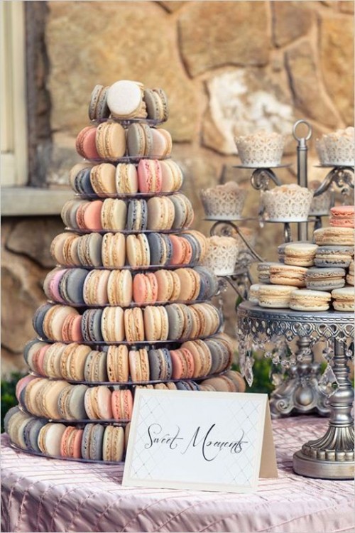 a macaron tower with a clear stand and macarons of various colors, a stand with matching cupcakes instead of a usual wedding cake