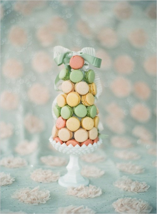 a mini pastel macaron tower with a matching bow on top is a gorgeous idea for a modern wedding with a touch of color, especially in spring