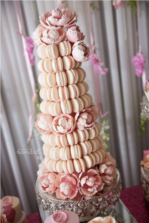 a super glam and beautiful blush macaron tower with edible pearls and pink blooms is a very chic and lovely idea for your glam wedding