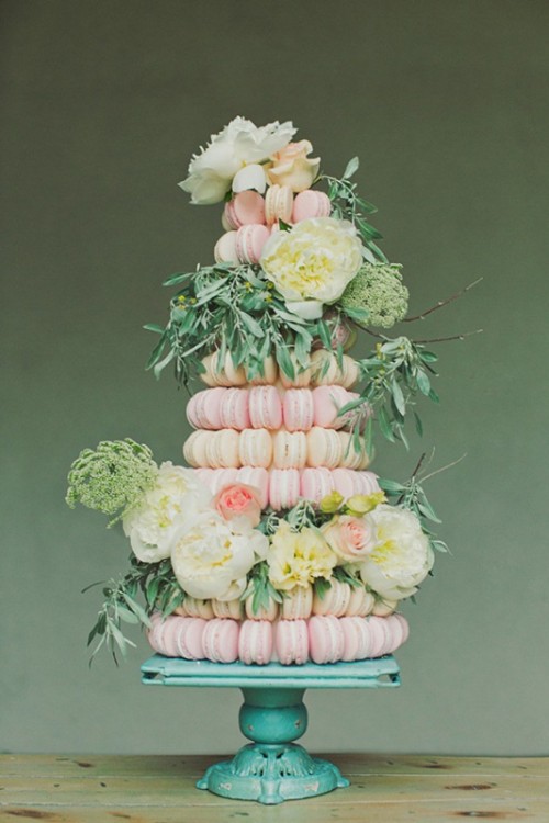 a gorgeous pink and white macaron tower decorated with neutral and pink blooms and lots of greenery is a fantastic idea to rock