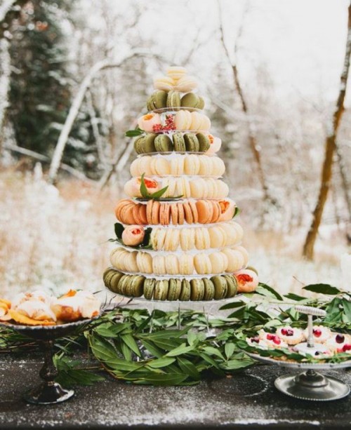 a pretty macaron tower of white, green and peachy macarons placed on a clear stand seems to be floating in the air is a gorgeous idea for a modern wedding