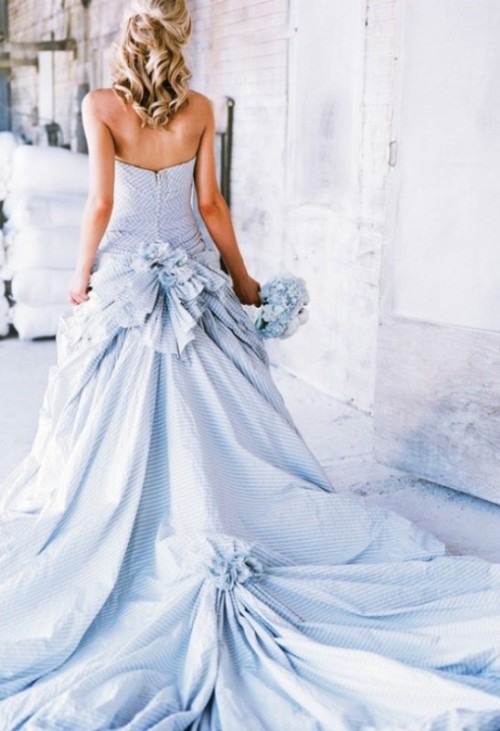 a striped blue strapless wedding ballgown with bows and a train and drapes is a catchy idea for a nautical or coastal wedding