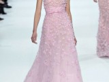 a sleeveless pink A-line wedding dress with embellishments, floral appliques and a sash and a train is a pretty and delicate idea