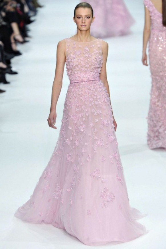 A sleeveless pink A line wedding dress with embellishments, floral appliques and a sash and a train is a pretty and delicate idea