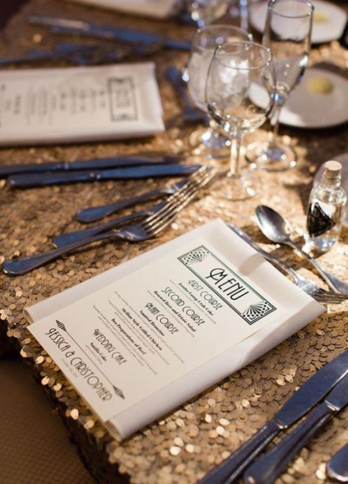 a glam 1920s tablescape with a copper sequin tablecloth, elegant menus and black cutlery is a very cool idea for the 1920s parties