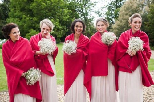 bright red coverups keep the bridesmaids warm and add color to their looks