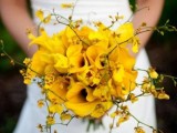 a yellow orchid wedding bouquet with billy balls and twigs is a bold and catchy solution for a summer or fall bride